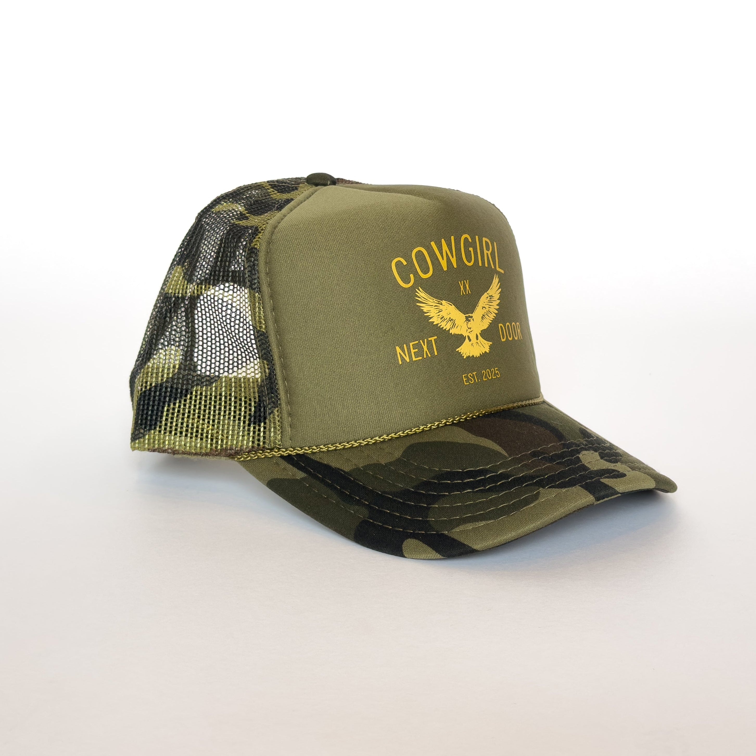 Green camouflage baseball cap with 'Cowgirl Next Door' text on a green background